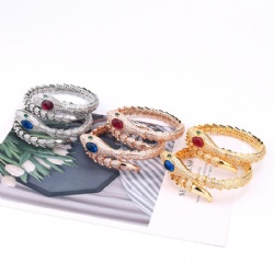 Serpentine bracelet design encrusted with diamonds encrusted with zircon green eyes gold silver